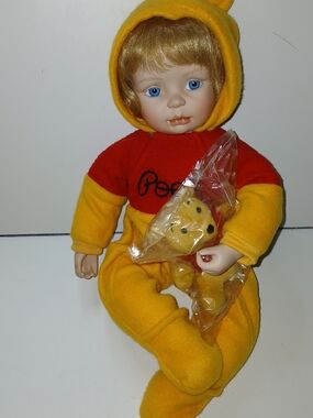 Ashton Drake "You Need A Hug, Pooh" doll is a porcelain and cloth collectible